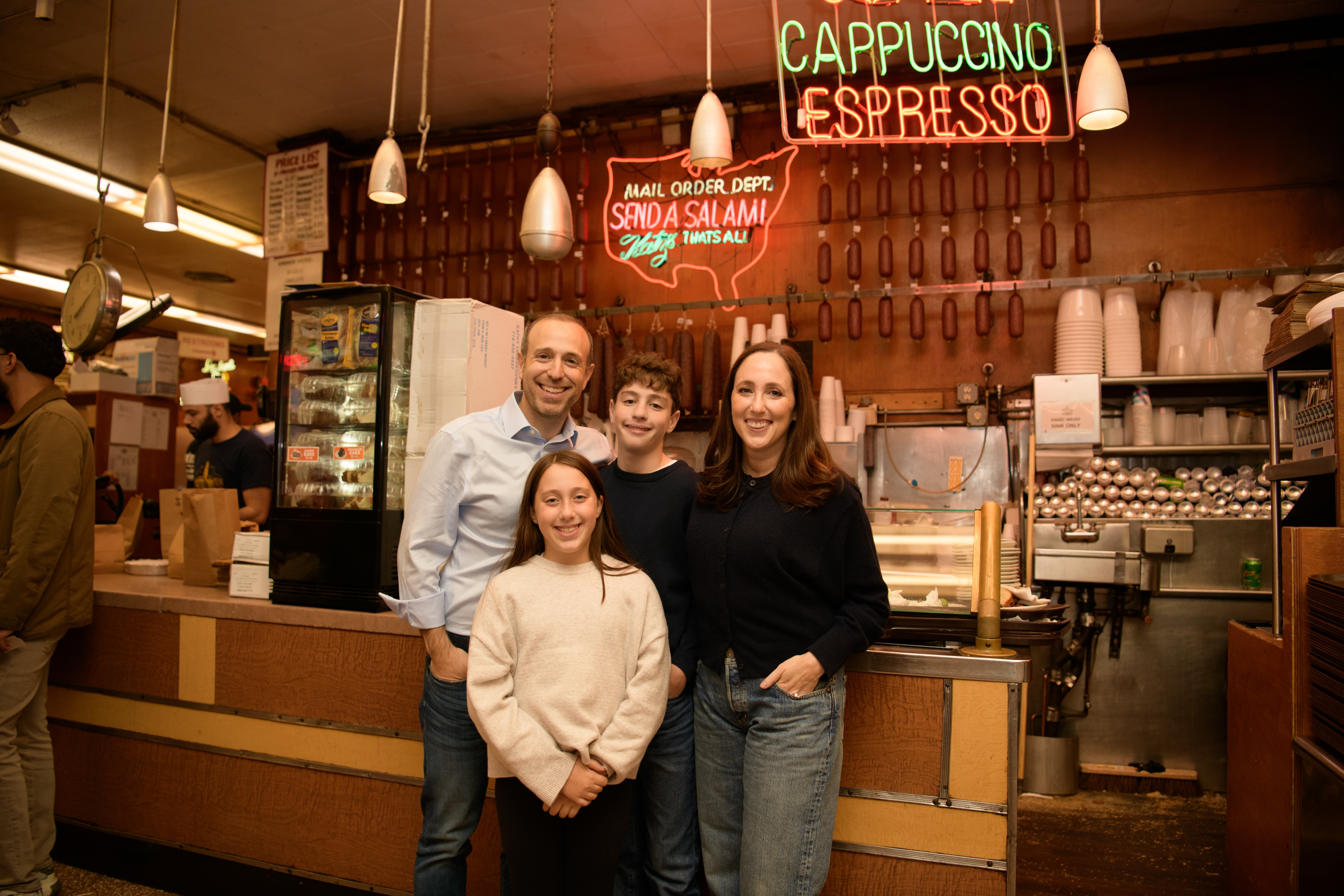 The Weckstein family standing together inside Katz's Delicatessen